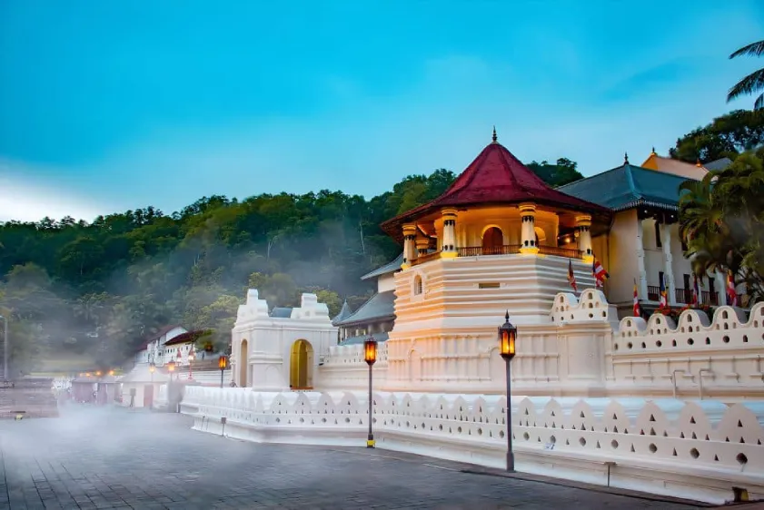 “Temple of the Tooth in Kandy illuminated at night”