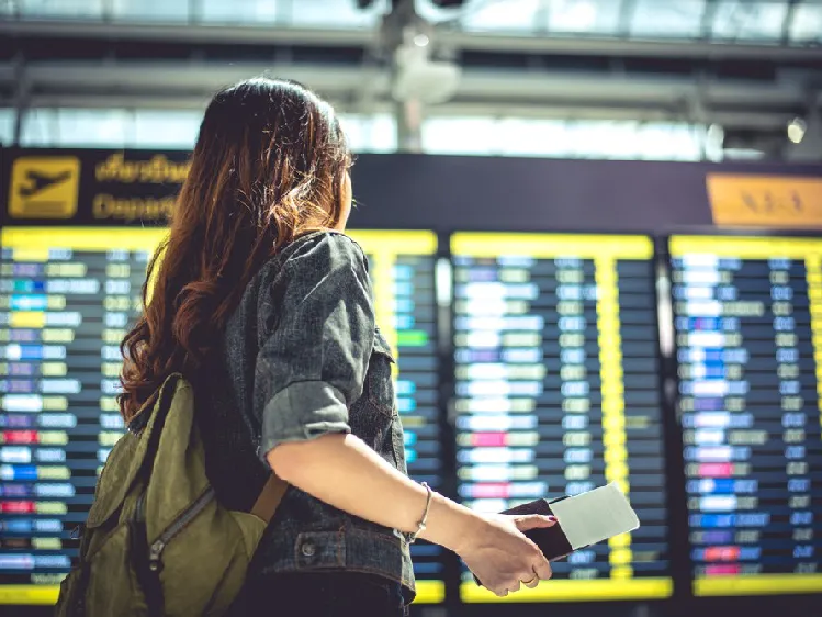 A girl watching airplane departure times