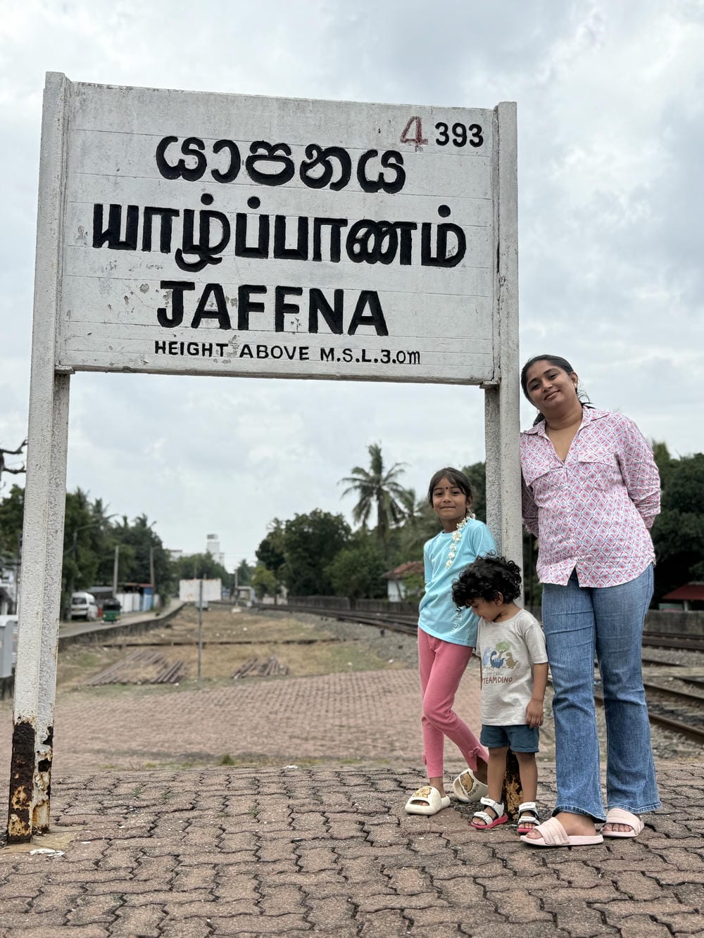 Family photo at the Jaffna station sign