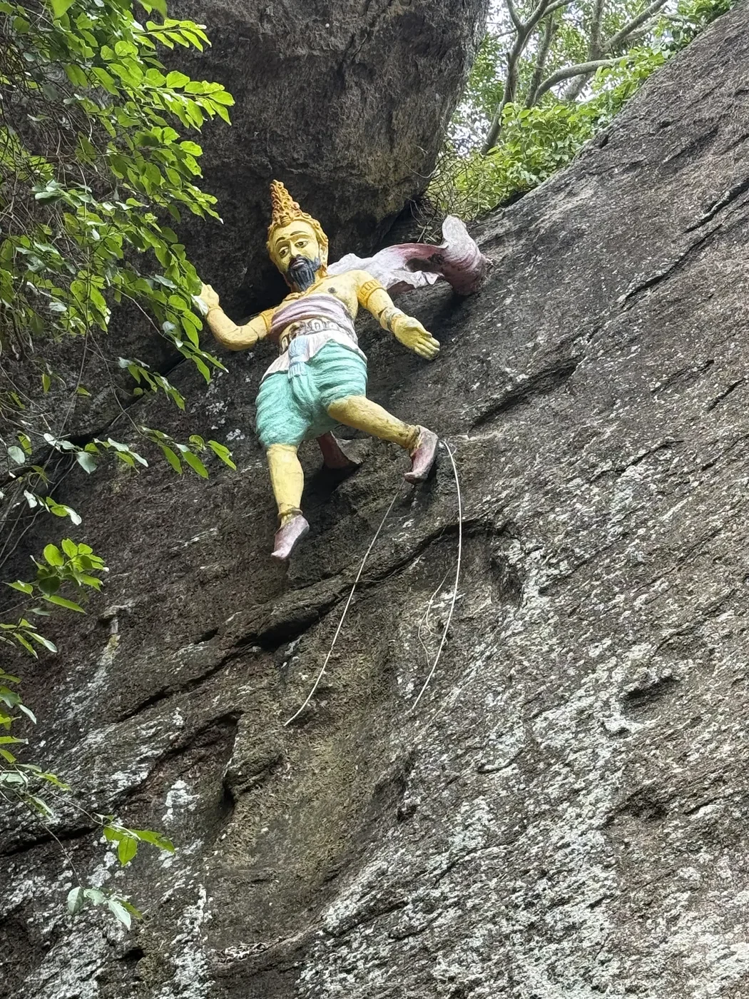 Painted statue on a rock wall