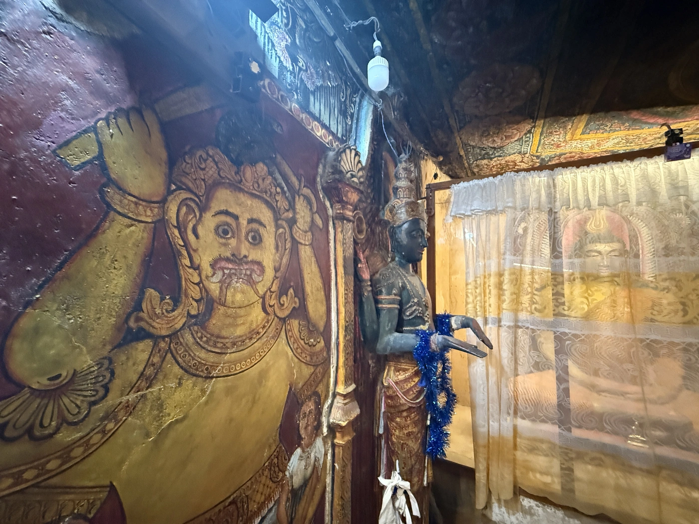 Guardian mural and deity statue in the shrine