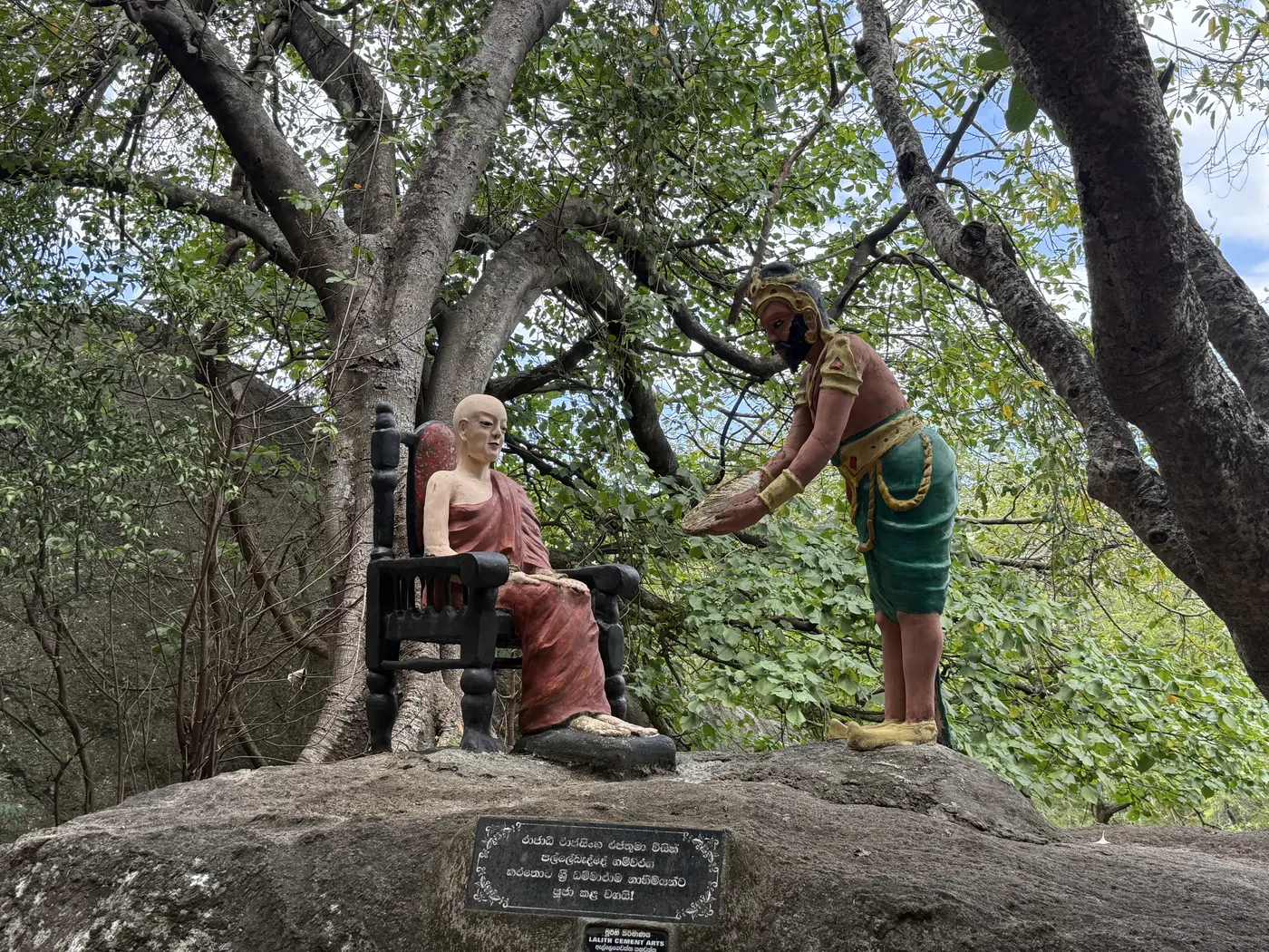 Statue of a monk and a king under a tree