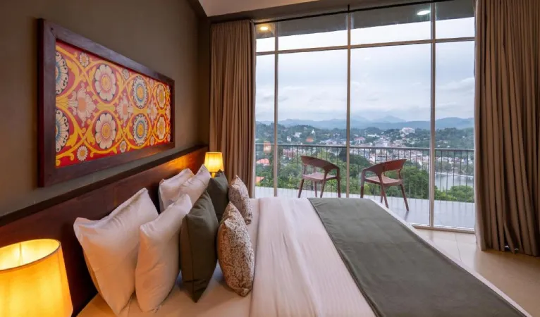 Bedroom with floor-to-ceiling windows and a balcony over Kandy at 360 View Point