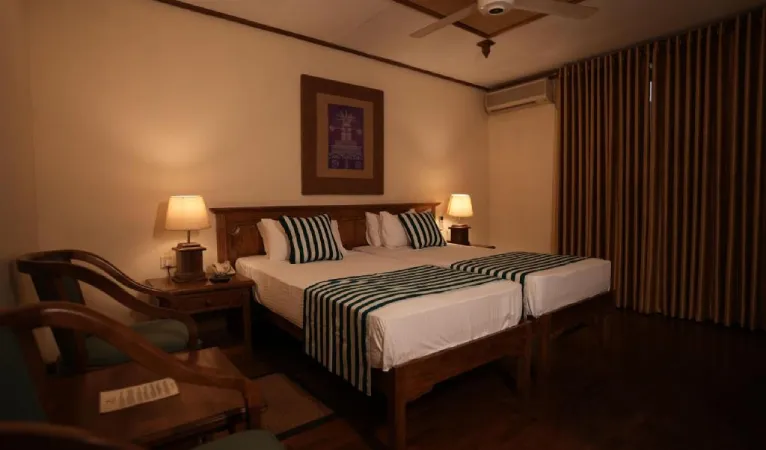 Twin room with striped bedspreads at Hotel Casamara Kandy