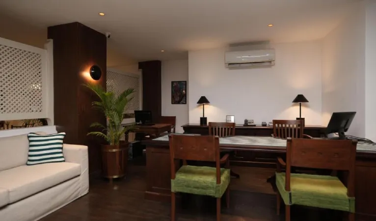 Guest room seating with a sofa and writing desk at Hotel Casamara Kandy