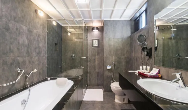 Grey stone bathroom with bathtub at Cinnamon Citadel Kandy