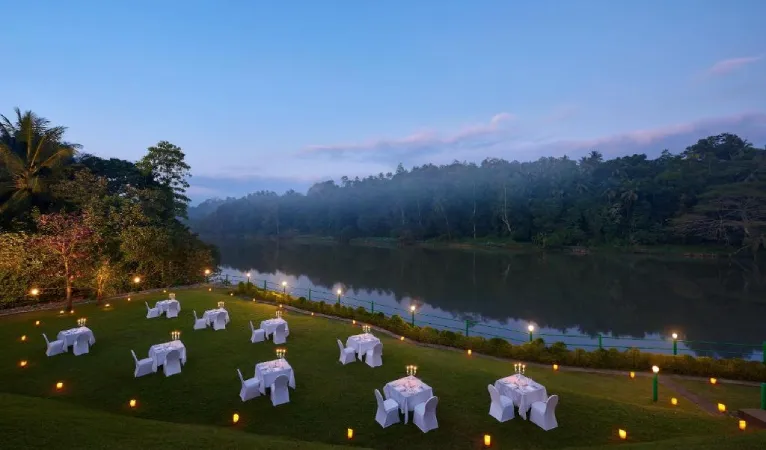 Candlelit dinner tables on the lawn by the Mahaweli River, Cinnamon Citadel Kandy