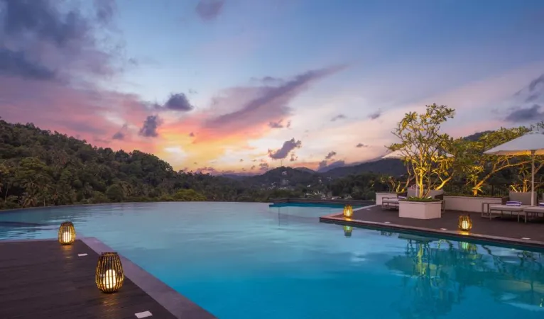 Infinity pool at sunset overlooking the hills at The Golden Crown Hotel Kandy