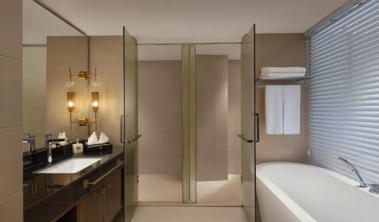 Bathroom with freestanding tub and glass shower at The Golden Crown Hotel
