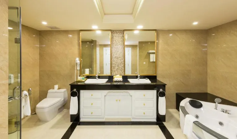 Marble bathroom with double sinks and a jacuzzi tub at The Grand Kandyan Hotel