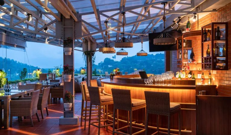 Sky bar with lit counter and bar stools at Grand Serendib Hotel Kandy