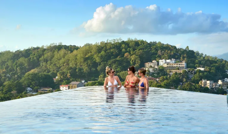 Guests in the infinity pool overlooking Kandy's forested hills at Grand Serendib Hotel