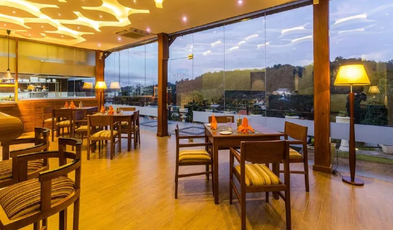 Restaurant with glass walls and hill views at dusk, Heaven Seven Hotel Kandy