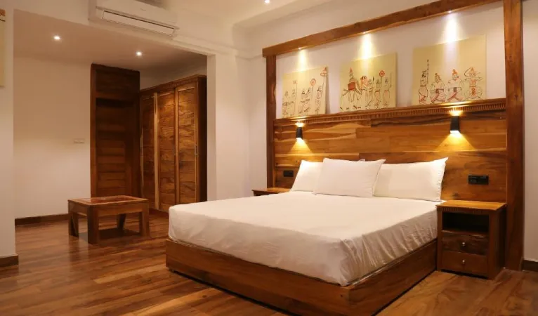 Double room with a wooden headboard and artwork at Lakewood Residence Kandy
