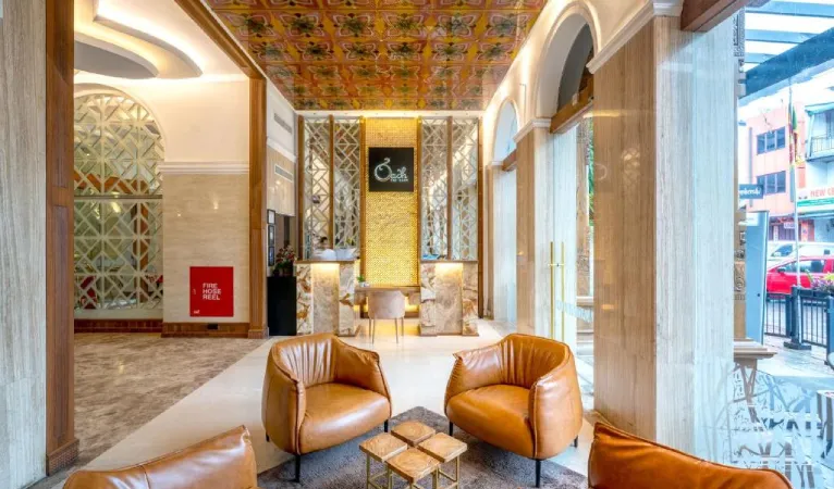 Lobby with leather armchairs and an ornate ceiling at The Radh Hotel Kandy