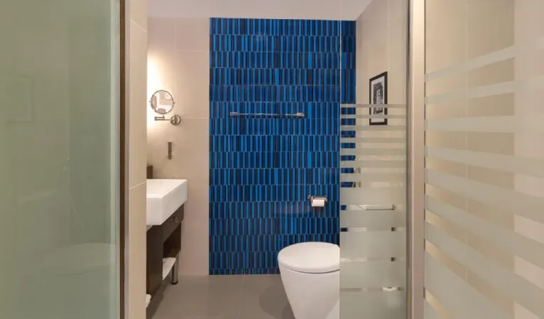 Bathroom with a blue tiled feature wall at Radisson Hotel Kandy
