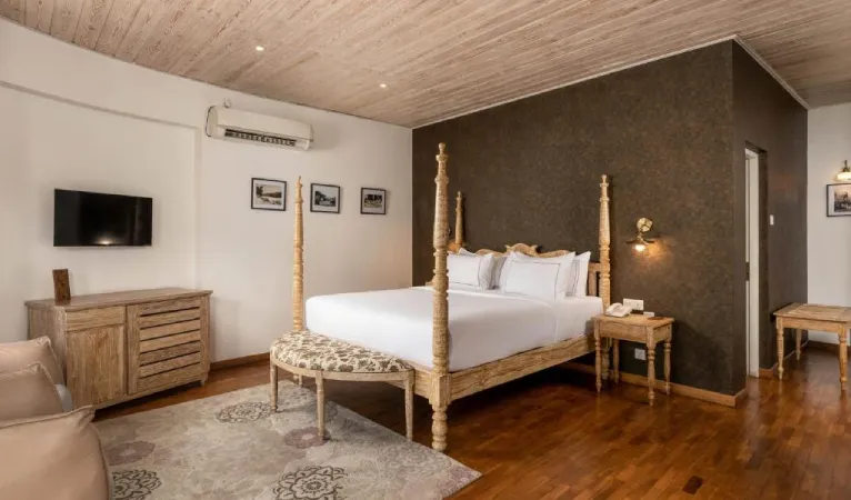 Room with a four-poster bed and wooden floor at Ru Boutique Kandy