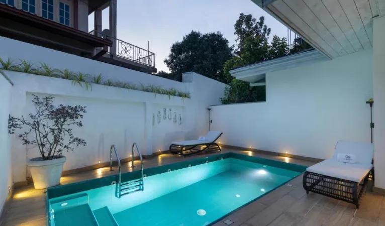 Plunge pool in a white-walled courtyard at dusk, Ru Boutique Kandy