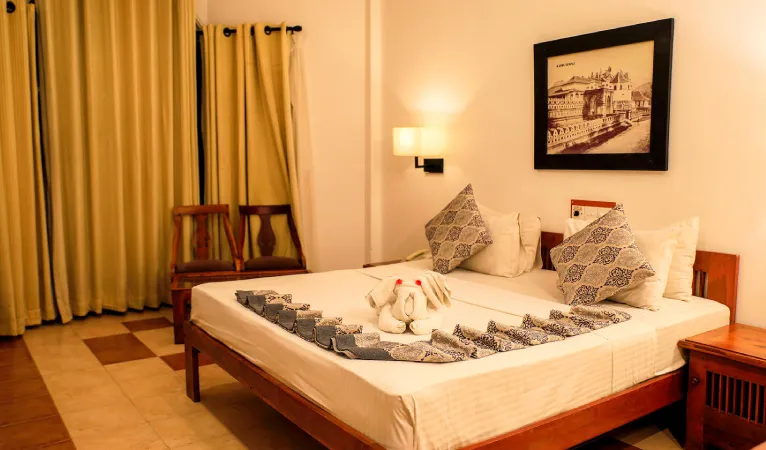 Double room with towel swans on the bed at Senani Hotel Kandy