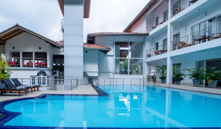 Swimming pool beside the hotel building at Senani Hotel Kandy