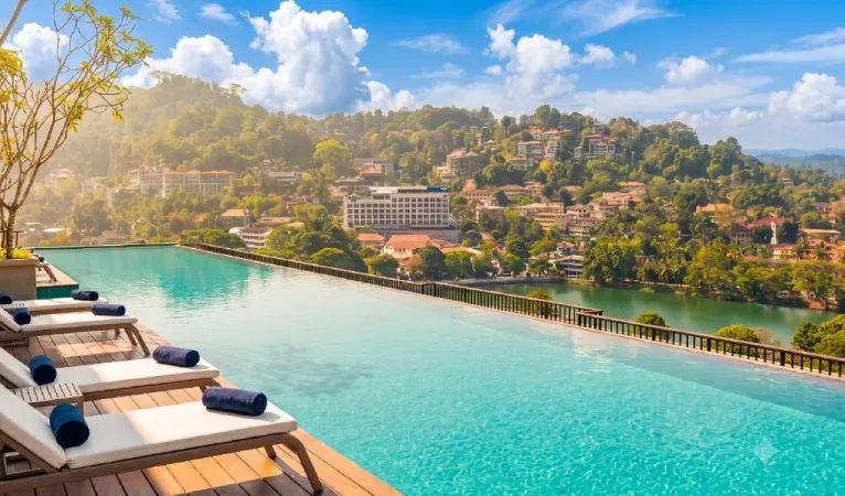 Infinity pool with sun loungers overlooking Kandy town at Thilanka Hotel
