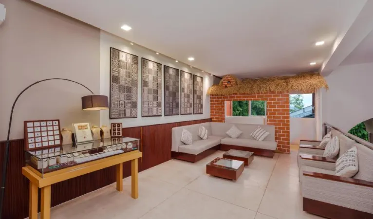 Suite lounge with white sofas and framed wall art at Hotel Topaz