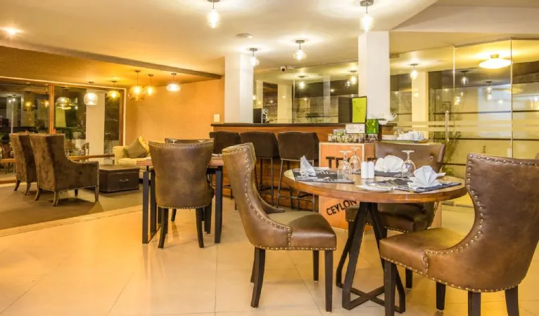 Restaurant with leather chairs at Viyana Boutique Hotel Kandy