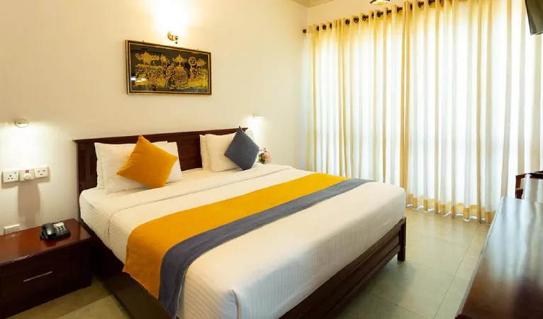 Double room with orange and grey bed runner at Hotel Yo Kandy